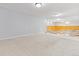 Spacious basement with carpeted floor, white walls and wood paneling at 2172 S Harlan St, Denver, CO 80227