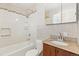 Bathroom featuring a tub and shower, with a mosaic backsplash and granite vanity at 2172 S Harlan St, Denver, CO 80227