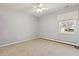 An empty bedroom featuring a ceiling fan, carpet, and a bright window at 2172 S Harlan St, Denver, CO 80227