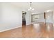 Open dining room with hardwood floors and view of kitchen and entryway at 2172 S Harlan St, Denver, CO 80227