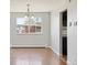 Open dining room with hardwood floors, chandelier, large windows at 2172 S Harlan St, Denver, CO 80227