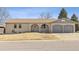 Charming single-story home with arched entryway, brick facade, and a two-car garage in a residential neighborhood at 2172 S Harlan St, Denver, CO 80227