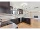 Modern kitchen with dark cabinets, granite countertops, stainless steel appliances and view of dining area at 2172 S Harlan St, Denver, CO 80227