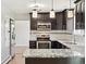 This kitchen features espresso cabinets, stainless steel appliances, and granite countertops, perfect for cooking at 2172 S Harlan St, Denver, CO 80227