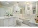 Traditional bathroom design featuring double sinks, tiled tub, and abundant mirror surfaces at 44 S Holman Way, Golden, CO 80401