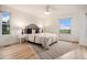 This bedroom is bright, featuring a ceiling fan, hardwood floors and picturesque views at 44 S Holman Way, Golden, CO 80401