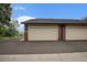 View of the two-car garage with brick facade and paved driveway at 44 S Holman Way, Golden, CO 80401