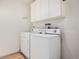 Convenient laundry area with a white washer and dryer set, plus overhead cabinets for storage at 44 S Holman Way, Golden, CO 80401