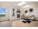 Bright room with a fireplace, sky lights, and views of the outdoors at 44 S Holman Way, Golden, CO 80401