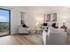 Bright living room with new wood floors, neutral furniture, and a sliding glass door at 44 S Holman Way, Golden, CO 80401