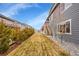 View of backyard featuring a well-maintained lawn surrounded by trees and neighboring houses at 5190 Ditmars Trl, Castle Rock, CO 80104