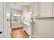Large bathroom with dual vanities, wood floors, and a walk-in closet with shelving at 5190 Ditmars Trl, Castle Rock, CO 80104