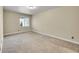 Bedroom with a large window and neutral carpet and walls at 5190 Ditmars Trl, Castle Rock, CO 80104