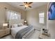 Bright bedroom with large upholstered headboard, soft neutral tones, and lots of natural light at 5190 Ditmars Trl, Castle Rock, CO 80104
