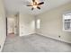 Spacious bedroom featuring neutral walls and carpet with a ceiling fan, doorway, and window at 5190 Ditmars Trl, Castle Rock, CO 80104