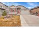 Charming two-story home featuring stone accents, a two-car garage, and a well-maintained front yard at 5190 Ditmars Trl, Castle Rock, CO 80104