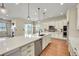 Bright kitchen featuring a large island with quartz countertop, stainless steel appliances, and hardwood floors at 5190 Ditmars Trl, Castle Rock, CO 80104