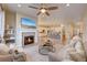Cozy living room with modern fireplace and large TV, open to the kitchen and dining area at 5190 Ditmars Trl, Castle Rock, CO 80104
