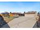 A spacious backyard with a concrete pad, trampoline, covered patio, detached garage and ample space for outdoor fun at 96 S Depew Dr, Lakewood, CO 80226