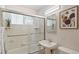 Bathroom with a glass-enclosed shower, tile surround, and decorative accents at 96 S Depew Dr, Lakewood, CO 80226