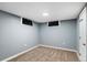 Finished basement bedroom with a light gray paint, neutral carpet, two windows and interior door at 96 S Depew Dr, Lakewood, CO 80226
