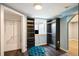 Walk-in closet features custom shelves, hardwood floors, lighting, a window, and an adjoining closet space at 96 S Depew Dr, Lakewood, CO 80226