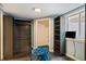 Walk-in closet featuring organizers, custom shelves, hardwood floors, lighting and a tufted ottoman at 96 S Depew Dr, Lakewood, CO 80226