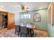 Cozy dining room with a wooden table, seating for six, and a charming ceiling fan at 96 S Depew Dr, Lakewood, CO 80226