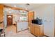 Kitchen area with tiled floors, lots of cabinets, wooden trim, and stainless appliances at 96 S Depew Dr, Lakewood, CO 80226