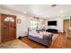 Cozy living room showcasing hardwood floors, a decorative window, a modern TV, and comfortable couches at 96 S Depew Dr, Lakewood, CO 80226