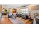 Inviting living room featuring hardwood floors, large windows, and stylish grey furniture at 96 S Depew Dr, Lakewood, CO 80226
