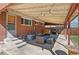 Comfortable covered patio featuring stylish seating and string lights for outdoor relaxation and entertaining at 96 S Depew Dr, Lakewood, CO 80226