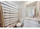 Well-lit bathroom with tile floors, shower/tub combo, and single sink vanity at 18066 E 104Th Way, Commerce City, CO 80022