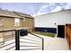 The home's backyard features a cement patio area, wooden fence, staircase, and a black grill at 2471 S High St, Denver, CO 80210