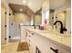 A modern bathroom with double vanity, black hardware, large mirrors, and a glass-enclosed shower at 2471 S High St, Denver, CO 80210