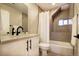 Neutral bathroom featuring shower with a glass enclosure, white vanity and modern fixtures at 2471 S High St, Denver, CO 80210