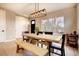 Inviting dining area with wood table, modern lighting, and convenient bench seating offers a cozy gathering space at 2471 S High St, Denver, CO 80210