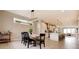 Bright dining room with modern chandelier, light wood table, and open floor plan flows into the updated kitchen at 2471 S High St, Denver, CO 80210