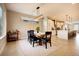 Bright dining room with modern chandelier, light wood table, and open floor plan flows into the updated kitchen at 2471 S High St, Denver, CO 80210