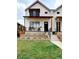 Charming two-story home with white siding, covered porch, and green lawn creates an inviting exterior at 2471 S High St, Denver, CO 80210