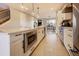 Bright open kitchen with island, modern appliances, and stylish pendant lighting creates a functional and attractive space at 2471 S High St, Denver, CO 80210