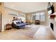 Bright living room with modern fireplace, tile flooring, and comfortable blue sectional sofa at 2471 S High St, Denver, CO 80210