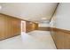 Spacious finished basement with neutral carpeting and wood paneling at 2994 S Winona Ct, Denver, CO 80236