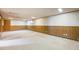 Finished basement featuring neutral carpeting and wood paneling at 2994 S Winona Ct, Denver, CO 80236