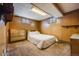 Finished basement bedroom with dresser and plush bedding at 2994 S Winona Ct, Denver, CO 80236