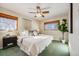 Main bedroom with a king-size bed, ceiling fan, and ample natural light at 2994 S Winona Ct, Denver, CO 80236