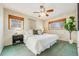 Spacious primary bedroom with ceiling fan and ample natural light at 2994 S Winona Ct, Denver, CO 80236