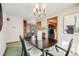 Dining room with table, chairs, and views into the kitchen and living areas at 2994 S Winona Ct, Denver, CO 80236