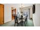 Bright dining room features a table with six chairs and views to the kitchen at 2994 S Winona Ct, Denver, CO 80236