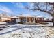 Brick ranch house with a snow-covered lawn at 2994 S Winona Ct, Denver, CO 80236